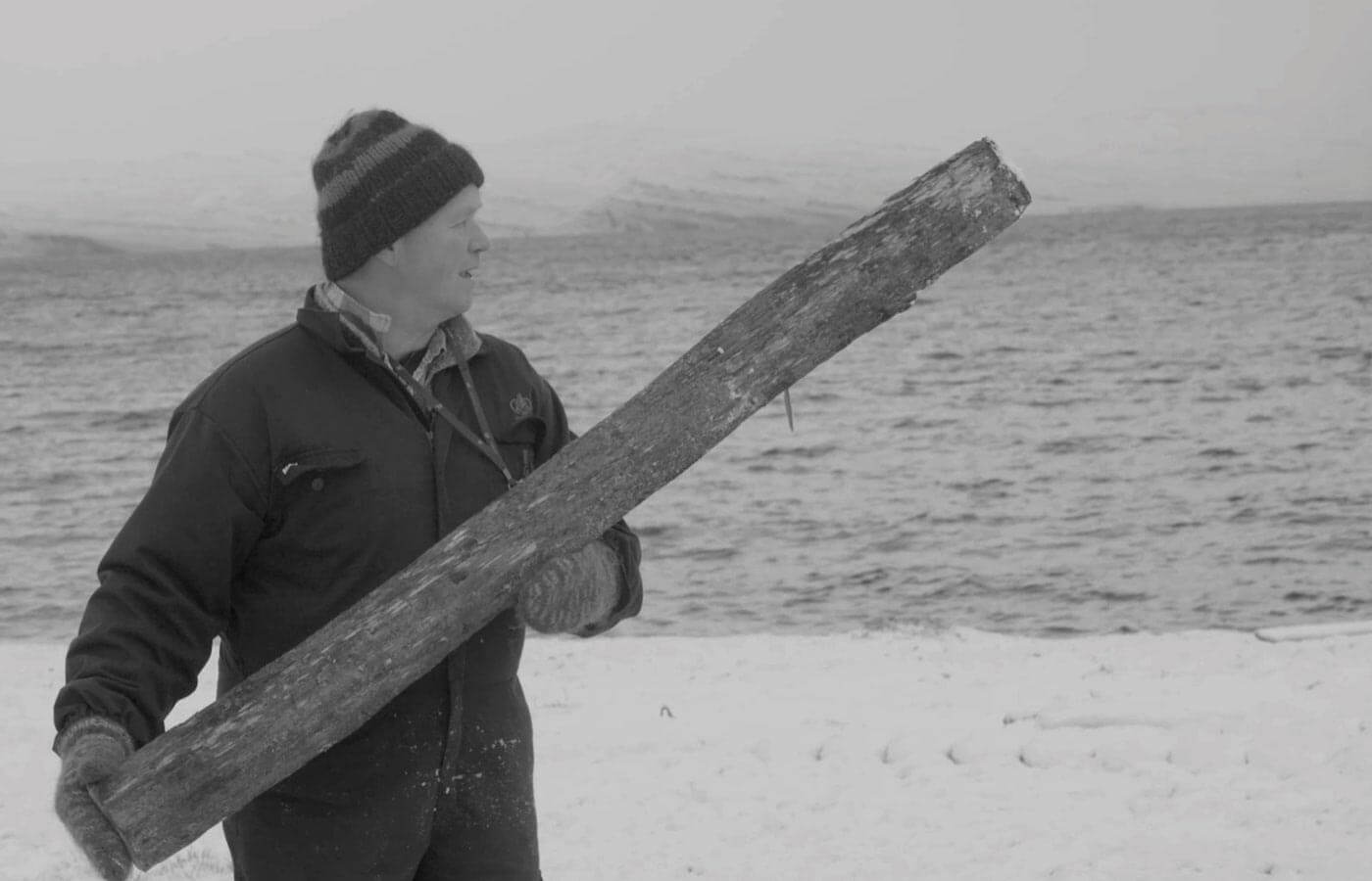 farmer holding a trunk in winter