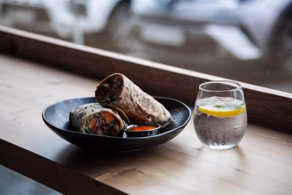 wrap of lamb and vegetables with a cold drink